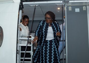 Ghana's Minister for Tourism, Culture and Creative Arts, Abla Dzifa Gomashie, being conducted around the aircraft