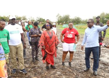 Ghana's Tourism minister (in red african print) together with some officials visiting many heritage sites in the Volta Region