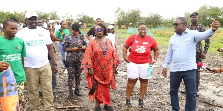 Ghana's Tourism minister (in red african print) together with some officials visiting many heritage sites in the Volta Region