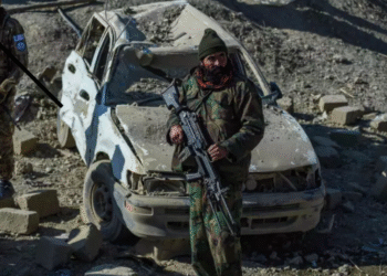 Taliban security personnel stand guard near a damaged car two days after air strikes by Pakistan in the Barmal district of eastern Paktika province on December 26, 2024. © Ahmad Sahel Arman, AFP
