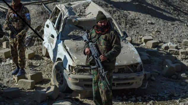 Taliban security personnel stand guard near a damaged car two days after air strikes by Pakistan in the Barmal district of eastern Paktika province on December 26, 2024. © Ahmad Sahel Arman, AFP