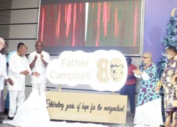 Sam Okudzeto (3rd from left) being assisted by Nana Appiagyei Dankawoso I (right), Chief, Asante Juaben Traditional Area, Dr Joyce Aryee (2nd from right), Rev. Father Andrew Campbell (left) and Dr Mahamudu Bawumia (2nd from left) to unveil the Father Andrew Campbell @ 80 logo