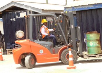 one of the women operating a heavy-duty machine