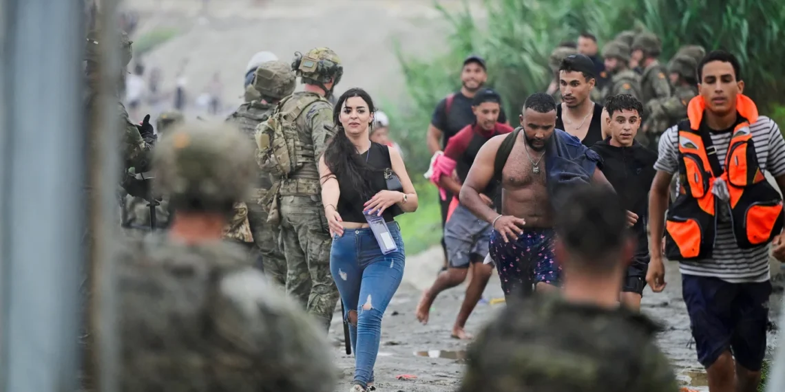 People from Morocco arrive at the Spanish border in Ceuta on 31 July 2026, as thousands enter the enclave by land and sea (Reuters)