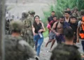 People from Morocco arrive at the Spanish border in Ceuta on 31 July 2026, as thousands enter the enclave by land and sea (Reuters)