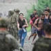 People from Morocco arrive at the Spanish border in Ceuta on 31 July 2026, as thousands enter the enclave by land and sea (Reuters)