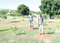 YAP personnel standing on the spots where the seedlings planted failed to survive
