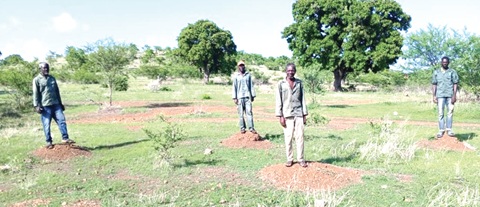YAP personnel standing on the spots where the seedlings planted failed to survive